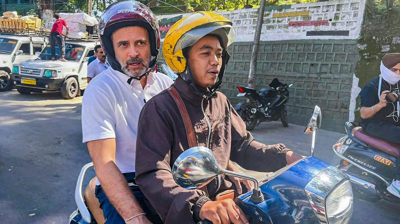 Aizawl: Congress leader Rahul Gandhi rides a two-wheeler during his visit to Mizoram ahead of upcoming State Assembly elections, in Aizawl, Tuesday, Oct. 17, 2023. (PTI Photo)