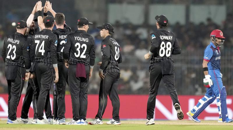 Chennai: New Zealand's Matt Henry celebrates with teammates after taking the wicket of Afghanistan’s Rahmanullah Gurbaz during the ICC Men's Cricket World Cup 2023 match between New Zealand and Afghanistan, at M. A. Chidambaram Stadium, in Chennai, Wednesday, Oct. 18, 2023. (PTI Photo/R Senthil Kumar)