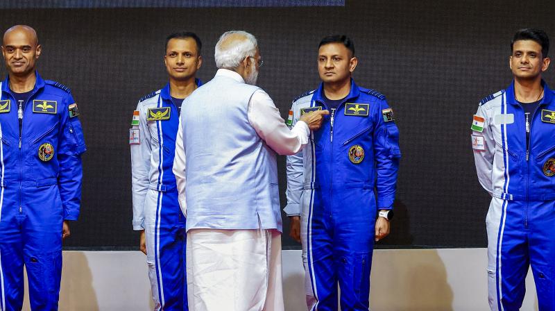 Thiruvananthapuram: Prime Minister Narendra Modi hands-over wings to astronauts-designate Shubanshu Shukla, Prashanth Balakrishnan Nair, Angad Prathap and Ajit Krishnan who have been selected to be the astronauts on India’s first crewed mission to space 'Gaganyaan Mission', at the Vikram Sarabhai Space Centre (VSSC), in Thiruvananthapuram, Tuesday, Feb. 27, 2024. (PTI Photo)
