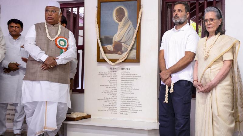 Congress President Mallikarjun Kharge with LoP in the Lok Sabha and party leader Rahul Gandhi, and party leader Sonia Gandhi during a prayer meet at the Sabarmati Ashram, in Ahmedabad. (AICC via PTI Photo)