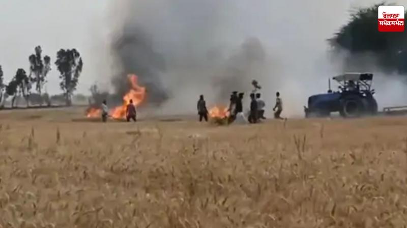 Farmer controlling fire with tractor