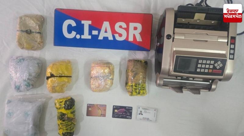 Image of 5 kg heroin, 1 currency counting machine and other items seized during the raid.
