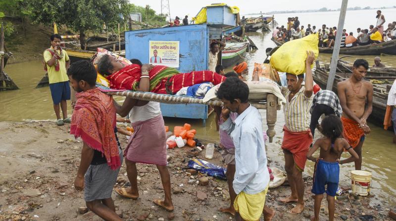 Patna: A sick woman being evacuated from a flood-affected area as the water level of the Ganga river continues to rise during the monsoon season, in Patna, Monday, Aug. 11, 2025. (PTI Photo)