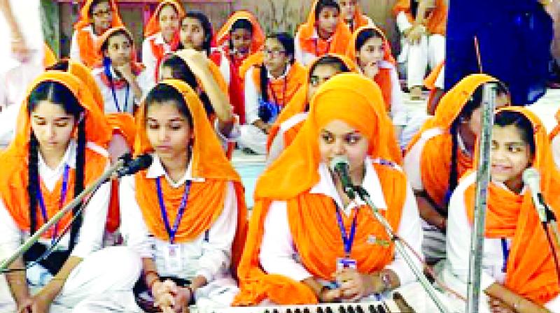 Girls are singing the words of GurBani on the occasion of Gurpurab.