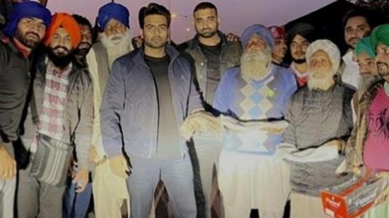  Mankirt Aulakh  distributes boots and warm shawls to elderly women and farmers