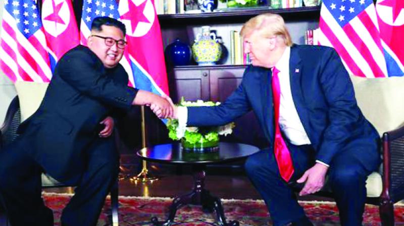 Kim Jong-Un shaking hands with Donald trump