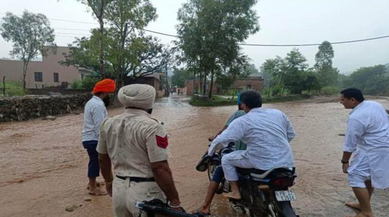 Manish Tewari crosses a rivulet on the way to Tandi village