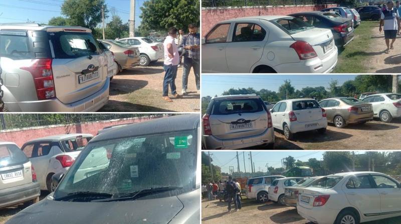 Unidentified persons broke the windows of two dozen vehicles 