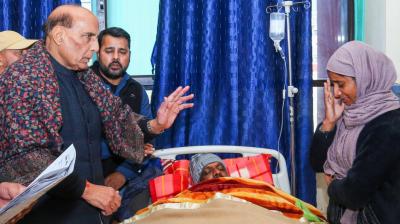 The Defense Minister Rajnath Singh with one of victim family.