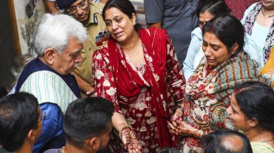 Jammu: Jammu and Kashmir Lieutenant Governor Manoj Sinha meets the family members of Shashi Bhushan Abrol, who was killed in a terrorist attack in J&K's Ganderbal on Sunday, in Jammu, Monday, Oct. 21, 2024. (PTI Photo)