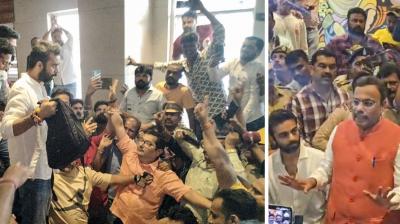 Mumbai: Bahujan Vikas Aghadi (BVA) candidate Kshitij Thakur (holding a bag) with supporters after they gheraod BJP leader Vinod Tawde, unseen, accusing him of distributing cash to influence voters a day before Maharashtra Assembly polls, at a hotel in Virar, near Mumbai, Tuesday, Nov. 19, 2024. Tawde denied the allegations, but an FIR has been registered against him after recovery of cash. (PTI Photo) 