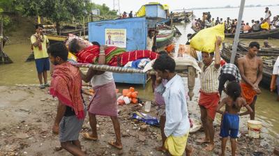 Patna: A sick woman being evacuated from a flood-affected area as the water level of the Ganga river continues to rise during the monsoon season, in Patna, Monday, Aug. 11, 2025. (PTI Photo)