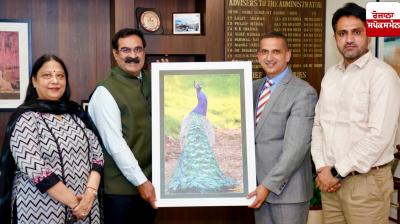 State Information Commissioner Harpreet Sandhu presents his artwork to the UT Chief Secretary