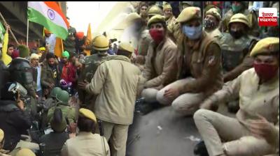 Police officials sit on road to block Road