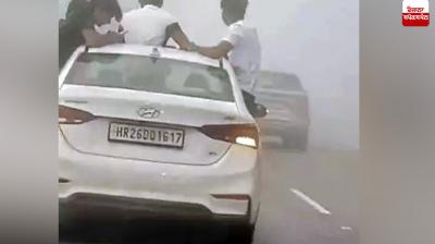 Youths perform stunts in a moving vehicle in Uttarakhand