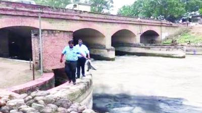 People Dropping Black Stuffed Bags In The Canal.