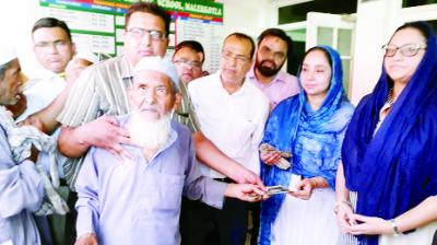 Razia Sultans and others at the time of distribution of pensions