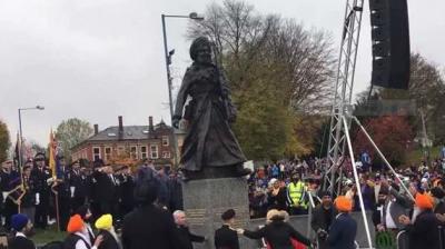 The statue stands on a granite plinth with inscriptions naming the regiments in which soldiers served.