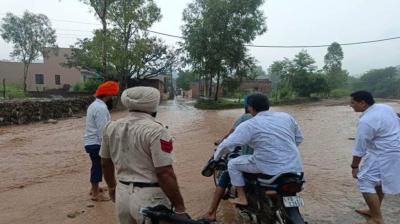 Manish Tewari crosses a rivulet on the way to Tandi village