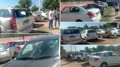 Unidentified persons broke the windows of two dozen vehicles 