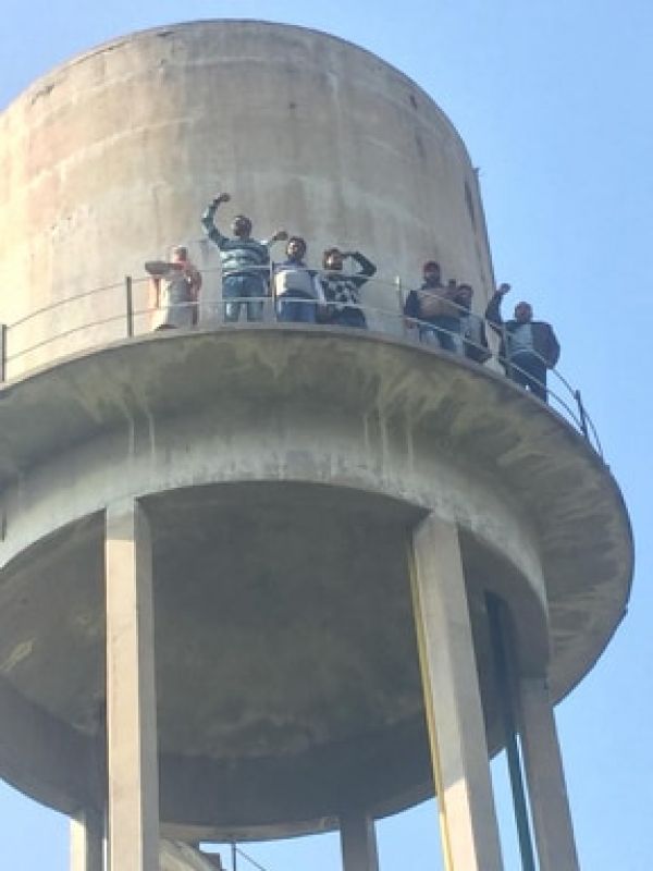 Powercom workers climb up on water tank-2
