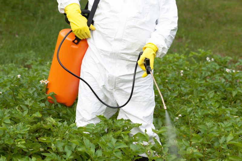 What should farmers wear while spraying?