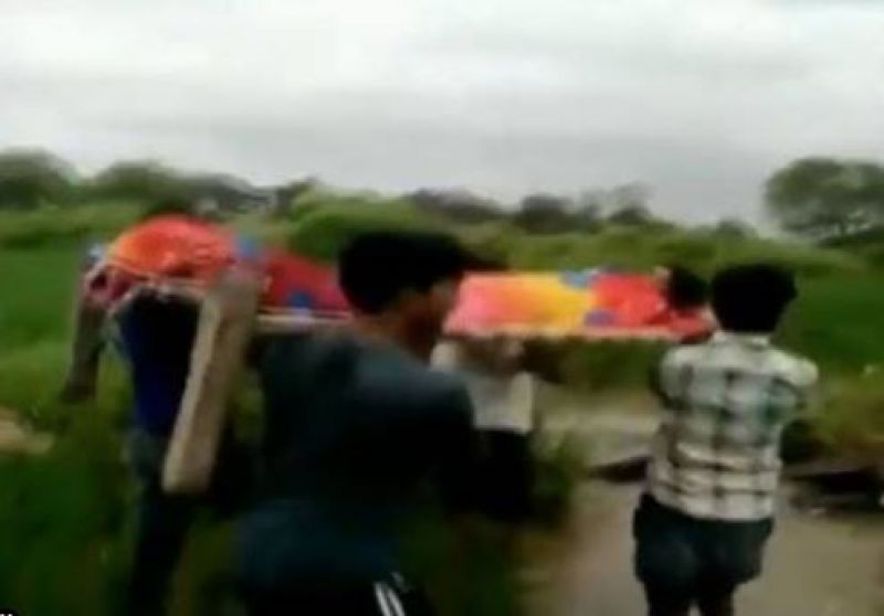 Patient carried to hospital on a cot