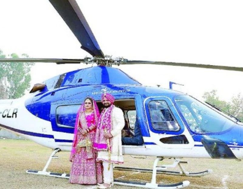 The groom brought the bride to the wedding in a helicopter
