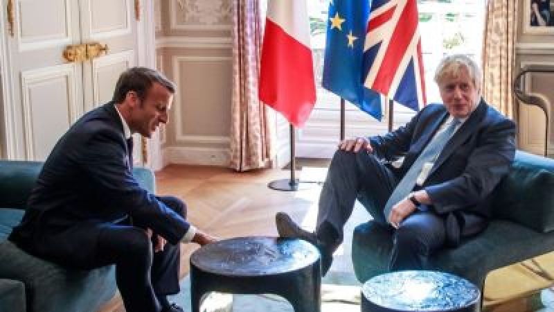 Foot on table: British PM at home in French president palace