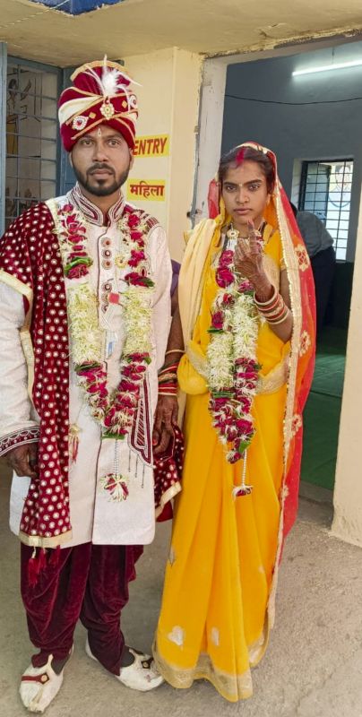 Newly-wedded couple at a polling station 