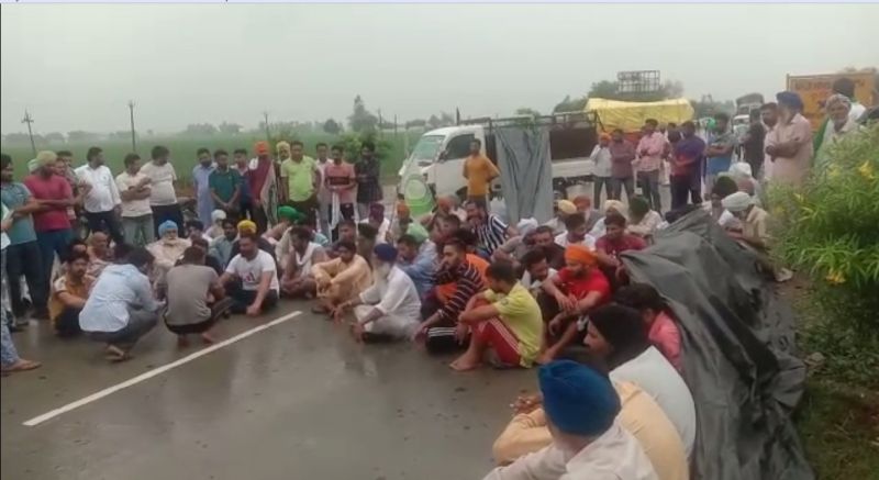Family members and villagers in the rain to bring justice to Lovepreet