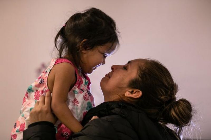 Sandra Sanchez holds Yanela in their basement apartment on Feb. 11. Sanchez said that she and her daughter were initially held by US immigration authorities for 18 days in three separate Texas detention facilities before being released pending an immigration court date.