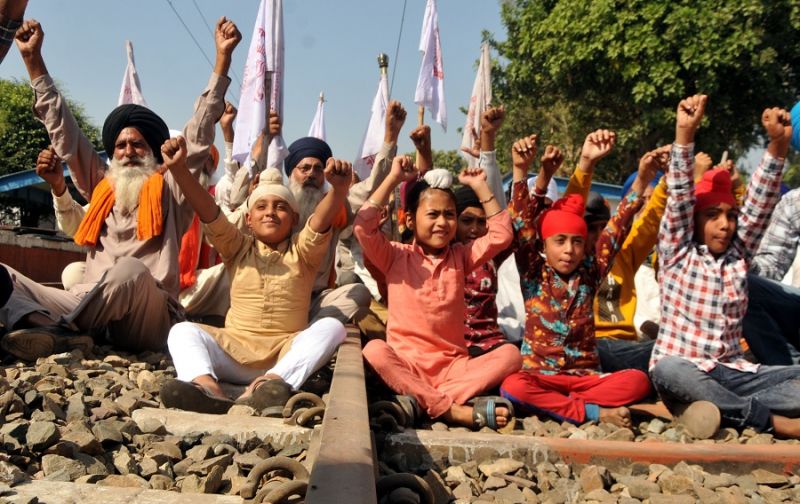 Flags of Kisan Unions in the hands of old women and children