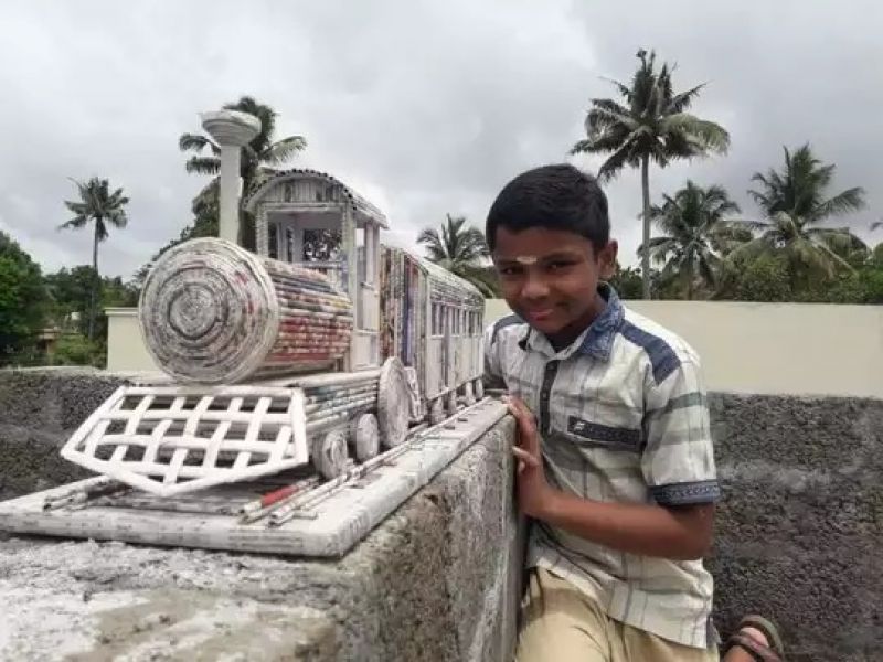 Boy creates train model using newspaper 