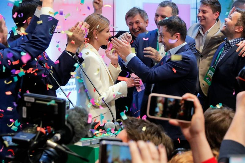 Volodymyr Zelenskiy, centre right, and his wife Olena Zelenska, greet supporters after exit polling gave the comedian a commanding lead