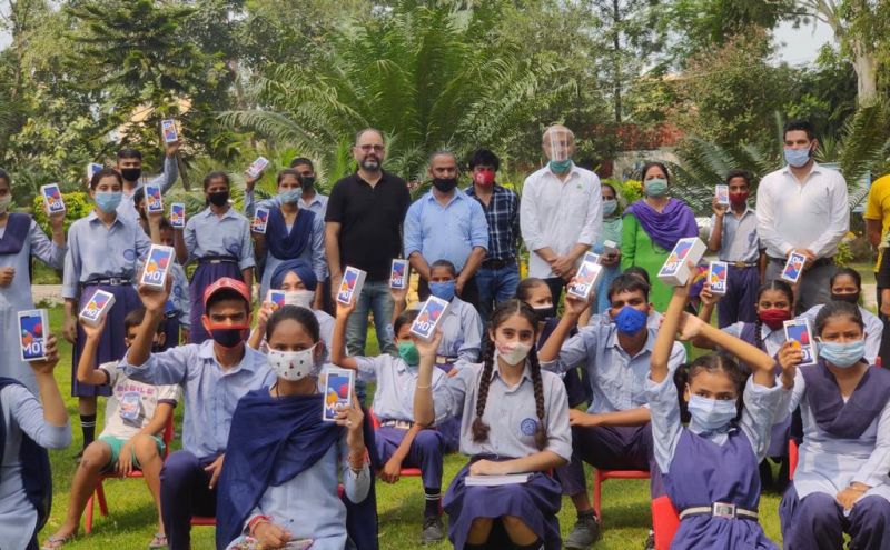 karan Gilhotra And Sonu Sood Distribute Smartphone 